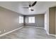 This bedroom features wood flooring, neutral paint, a ceiling fan, and natural light at 507 Satin Saddle Pl, Henderson, NV 89052
