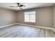 Bright bedroom with ceiling fan, wood-look floors, and large window at 507 Satin Saddle Pl, Henderson, NV 89052