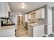 Modern kitchen featuring white cabinets, granite countertops, and stainless steel appliances at 507 Satin Saddle Pl, Henderson, NV 89052