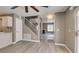 Open-concept living area showcasing staircase, light flooring, neutral colors and backyard access at 507 Satin Saddle Pl, Henderson, NV 89052