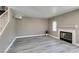Cozy living room with a fireplace, light flooring, neutral paint and stairs to the upper level at 507 Satin Saddle Pl, Henderson, NV 89052