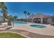 Community pool and spa with lounge chairs and palm trees at 507 Satin Saddle Pl, Henderson, NV 89052