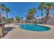 Community pool with lounge chairs and palm trees at 507 Satin Saddle Pl, Henderson, NV 89052