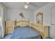 Cozy bedroom featuring light yellow furniture, ceiling fan, and natural light at 5139 Zapata Ln, North Las Vegas, NV 89031