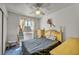 Cozy bedroom with a ceiling fan, carpet, and a bright window at 5139 Zapata Ln, North Las Vegas, NV 89031