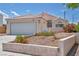 Inviting single-story home featuring a tile roof, front desert landscaping, and a two-car garage at 5139 Zapata Ln, North Las Vegas, NV 89031
