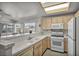 This kitchen features lots of natural light, tile counters and essential appliances at 5139 Zapata Ln, North Las Vegas, NV 89031