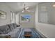 Cozy living room with vaulted ceilings, couch, ceiling fan and bright natural light at 5139 Zapata Ln, North Las Vegas, NV 89031