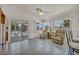 Bright, open living room with tile floors, ceiling fan, and sliding glass doors to the patio at 5139 Zapata Ln, North Las Vegas, NV 89031