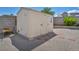 Close up view of a wooden shed on gravel with brick steps and some greenery at 5139 Zapata Ln, North Las Vegas, NV 89031