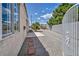 Side yard featuring a walkway, low-maintenance gravel, and privacy fencing for added seclusion at 5139 Zapata Ln, North Las Vegas, NV 89031