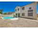 Backyard features a pool, stucco walls, clear blue sky, and desert landscaping at 5409 Flora Spray St, Las Vegas, NV 89130