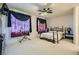 Relaxing bedroom with a comfortable bed, dark curtains, and a fan for a peaceful atmosphere at 5409 Flora Spray St, Las Vegas, NV 89130