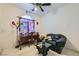 Cozy bedroom showcasing a comfortable couch, stylish desk, and decorative colorful floor lamp at 5409 Flora Spray St, Las Vegas, NV 89130