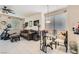 Cozy dining area with a glass-top table, chairs, and a ceiling fan for comfortable dining at 5409 Flora Spray St, Las Vegas, NV 89130