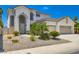 A home with a stucco exterior, a two car garage, and desert landscaping at 5409 Flora Spray St, Las Vegas, NV 89130