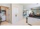 Bright kitchen features white cabinets, tiled floors, and easy access to the laundry area at 5409 Flora Spray St, Las Vegas, NV 89130