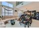 Spacious living room and dining area with a piano, comfortable seating, and large windows at 5409 Flora Spray St, Las Vegas, NV 89130