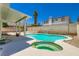 Backyard pool with a spa, covered patio, and well-maintained landscaping at 5409 Flora Spray St, Las Vegas, NV 89130