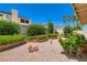 Beautifully landscaped backyard with small garden statues and lush foliage at 5413 Flora Spray St, Las Vegas, NV 89130
