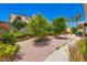 Enjoy the landscaped backyard with garden, stone and mature shade trees at 5413 Flora Spray St, Las Vegas, NV 89130