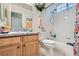 Well-lit bathroom with white tiled shower and granite countertop vanity at 5413 Flora Spray St, Las Vegas, NV 89130