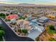 Aerial view of a home with a backyard pool, desert landscaping, and a spacious driveway at 5438 Sierra Brook Ct, Las Vegas, NV 89149