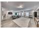 Spacious basement featuring hardwood floors, a bar, and a comfortable seating area at 5438 Sierra Brook Ct, Las Vegas, NV 89149
