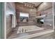 Spa-like bathroom featuring a large soaking tub, accent lighting, a fireplace, and modern finishes at 5438 Sierra Brook Ct, Las Vegas, NV 89149