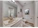 Clean bathroom with a vanity, a toilet, and decorative wainscotting along the walls at 5438 Sierra Brook Ct, Las Vegas, NV 89149