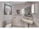 Stylish powder room with modern fixtures, a pedestal sink, and unique wall decorations at 5438 Sierra Brook Ct, Las Vegas, NV 89149