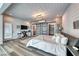 Contemporary bedroom with wood-look floors, sliding barn doors to bathroom, and access to a private balcony at 5438 Sierra Brook Ct, Las Vegas, NV 89149