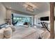 Relaxing bedroom featuring access to a large balcony with pool views, a dedicated office space, and modern decor at 5438 Sierra Brook Ct, Las Vegas, NV 89149