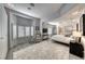 Open and airy bedroom with a plush rug, bay window, and seating area at 5438 Sierra Brook Ct, Las Vegas, NV 89149