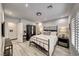 Comfortable bedroom with a queen bed, dark wood furnishings, and modern lighting fixtures at 5438 Sierra Brook Ct, Las Vegas, NV 89149