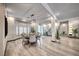 Formal dining area features a luxury chandelier and view of the decorative landscaping at 5438 Sierra Brook Ct, Las Vegas, NV 89149