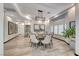 Dining area features a decorative chandelier and views of the front yard landscaping at 5438 Sierra Brook Ct, Las Vegas, NV 89149
