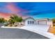 Single-story home boasting a wide driveway and three-car garage, enhanced by drought-tolerant landscaping at 5438 Sierra Brook Ct, Las Vegas, NV 89149