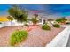 Well-manicured front yard with desert landscaping, mature trees, and a circular driveway at 5438 Sierra Brook Ct, Las Vegas, NV 89149