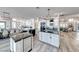 Open kitchen with white cabinetry, black countertops, and stainless steel appliances at 5438 Sierra Brook Ct, Las Vegas, NV 89149