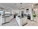 Modern kitchen features white cabinetry, black countertops, and stainless steel appliances at 5438 Sierra Brook Ct, Las Vegas, NV 89149