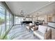 Open concept living room with hardwood floors, floor-to-ceiling windows and elegant seating arrangement at 5438 Sierra Brook Ct, Las Vegas, NV 89149