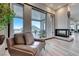 Inviting living room nook with a fireplace and comfortable chair overlooking the outside balcony at 5438 Sierra Brook Ct, Las Vegas, NV 89149