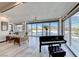 Bright living room featuring floor to ceiling windows, hardwood floors, and grand piano at 5438 Sierra Brook Ct, Las Vegas, NV 89149