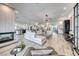 Open-concept living room with contemporary design, a fireplace, and seamless flow to the kitchen and dining areas at 5438 Sierra Brook Ct, Las Vegas, NV 89149