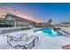 Stunning backyard pool with modern lounge chairs and adjacent covered patio, perfect for outdoor relaxation and entertaining at 5438 Sierra Brook Ct, Las Vegas, NV 89149