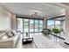 Bright sitting room featuring modern furnishings and a wall of glass doors leading to an outdoor patio at 5438 Sierra Brook Ct, Las Vegas, NV 89149
