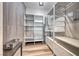 Bright walk-in closet with custom shelving, drawers, wood floors, and a decorative accent wall at 5438 Sierra Brook Ct, Las Vegas, NV 89149