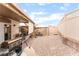 Spacious backyard with decorative stone, partially covered patio and grilling and entertaining area at 5733 Dazzling Sparks St, North Las Vegas, NV 89031