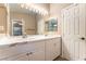 Well-lit bathroom with double sinks, marble countertops, and a large mirror with Hollywood lights at 5733 Dazzling Sparks St, North Las Vegas, NV 89031